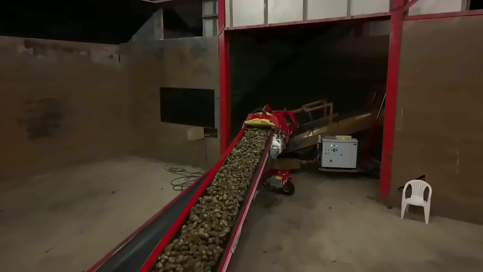 Lopende band die aardappelen de bewaarschuur in brengt